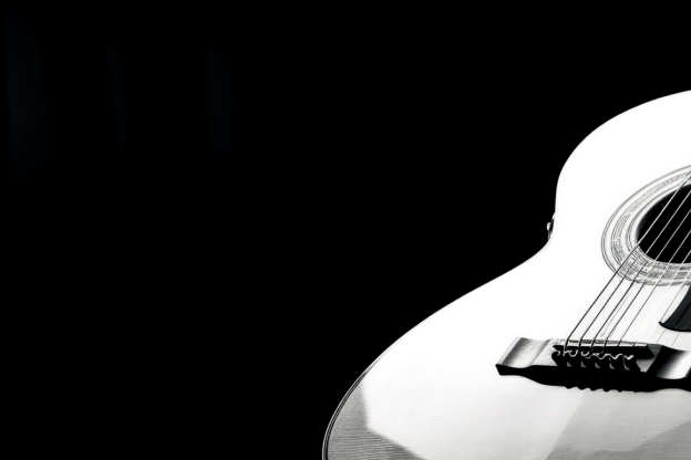 Violão com corda de aço em fundo preto
